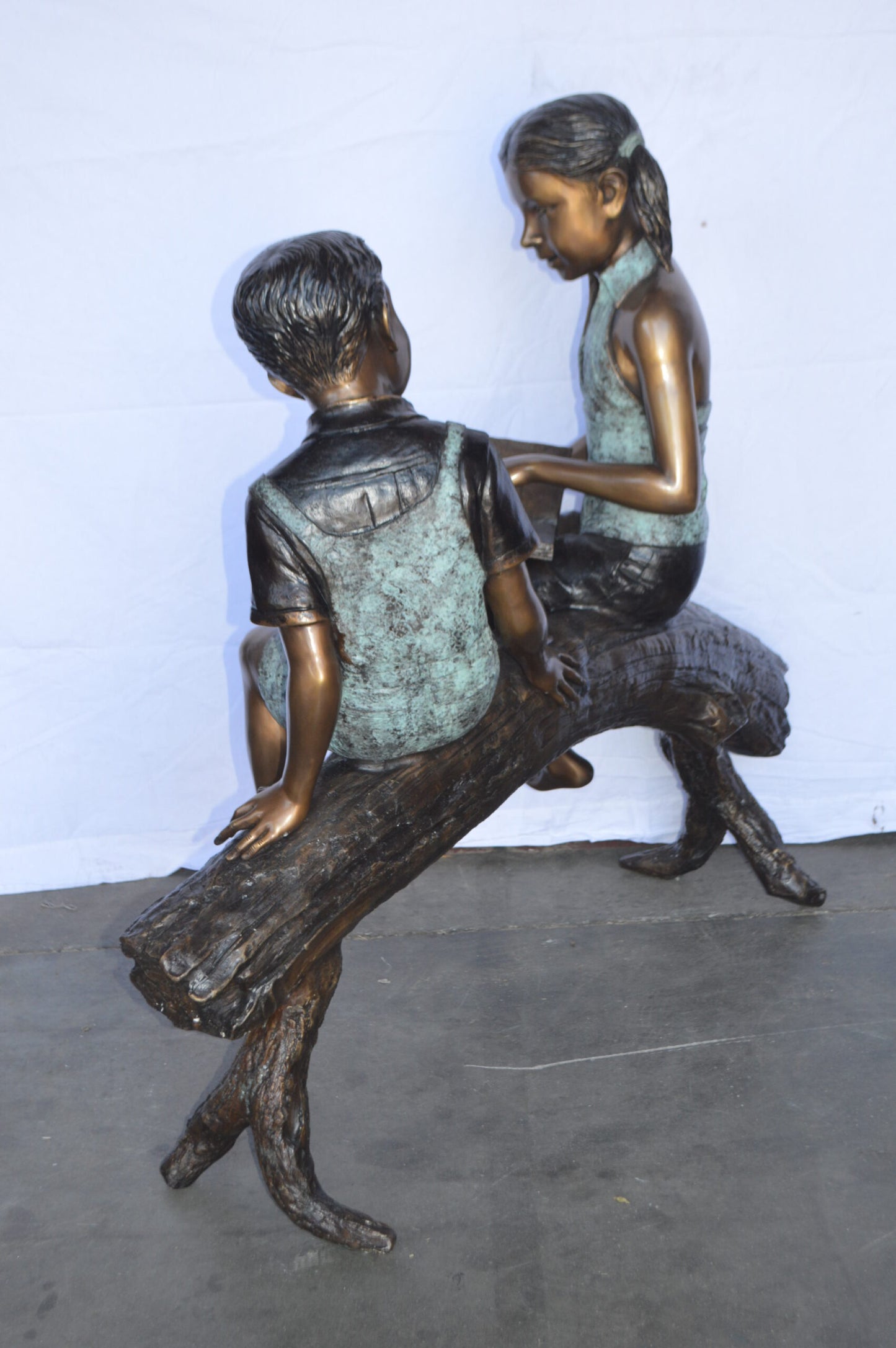 Two Kids on a tree log reading Bronze Statue Large -  Size: 44"L x 17"W x 42"H.