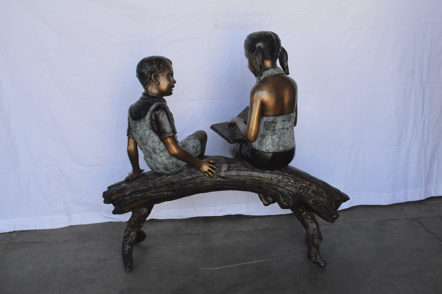 Two Kids on a tree log reading Bronze Statue Large -  Size: 44"L x 17"W x 42"H.