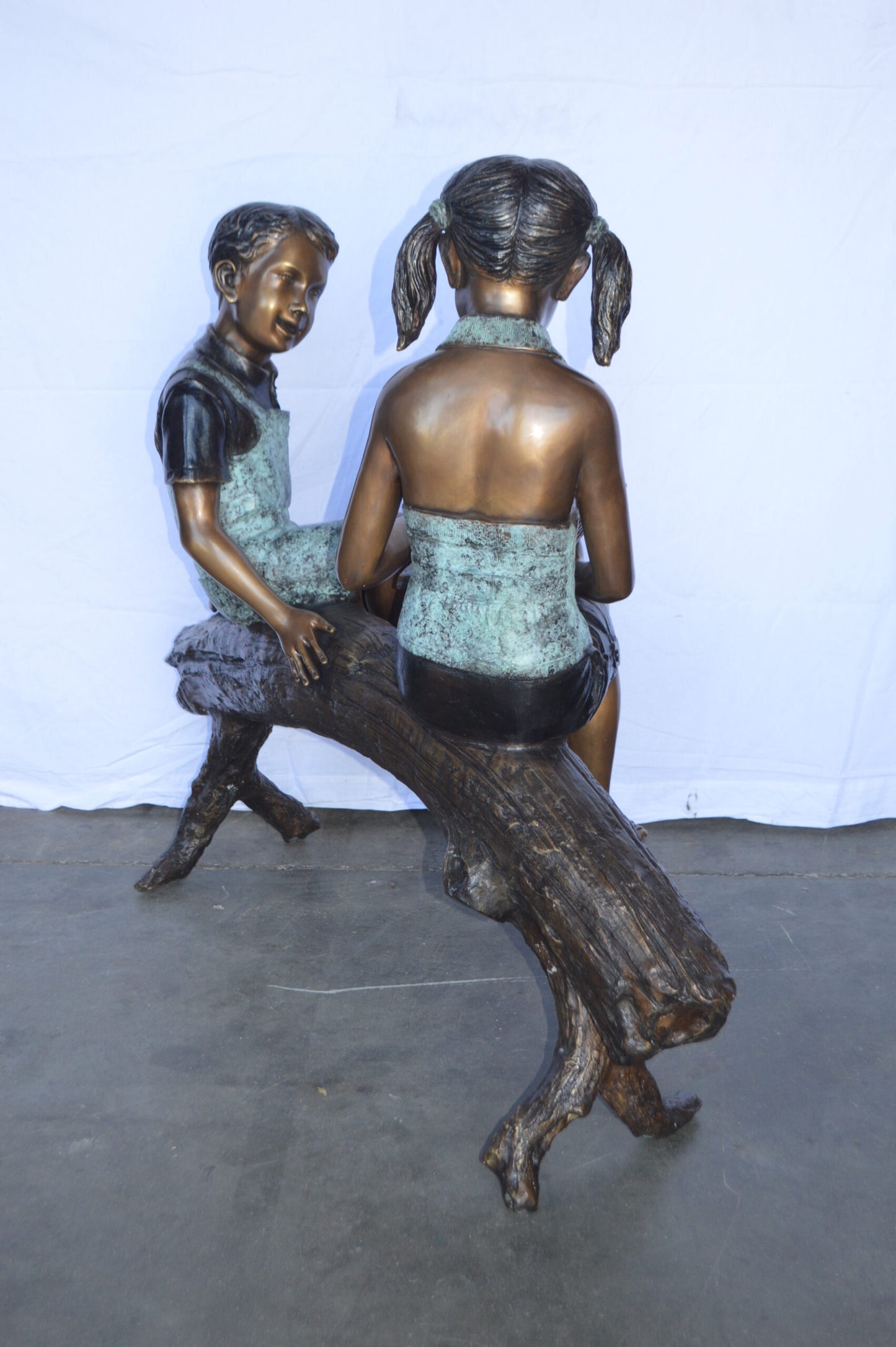 Two Kids on a tree log reading Bronze Statue Large -  Size: 44"L x 17"W x 42"H.