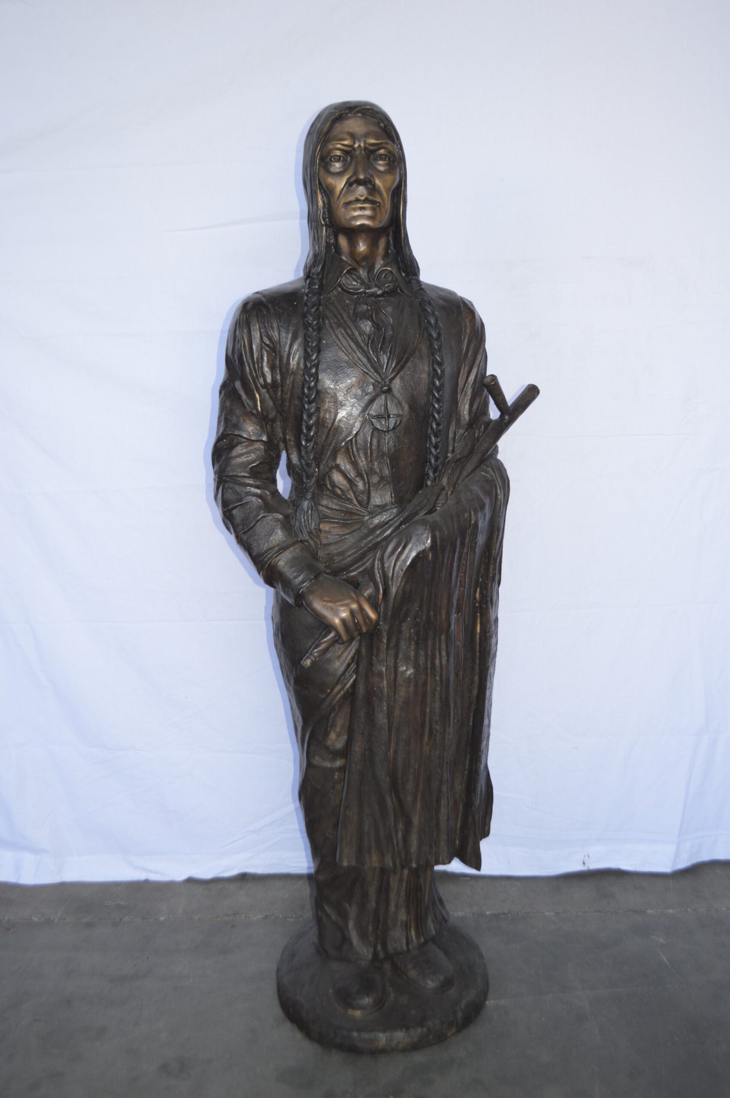 Indian Holding a Pipe Bronze Statue Life Size - Size: 26"L x 14"W x 68"H.