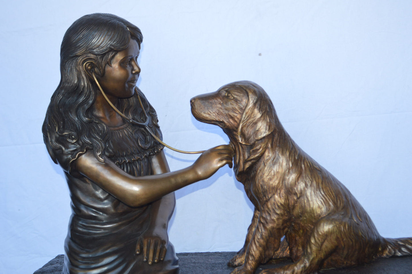 Girl plays Doctor on a Bench W Dog Bronze Statue - Size: 38"L x 18"W x 39"H.
