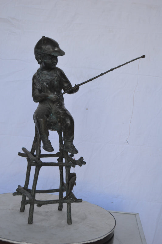A Boy on a high Chair Fishing Bronze Statue - Size: 16"L x 14"W x 28"H.
