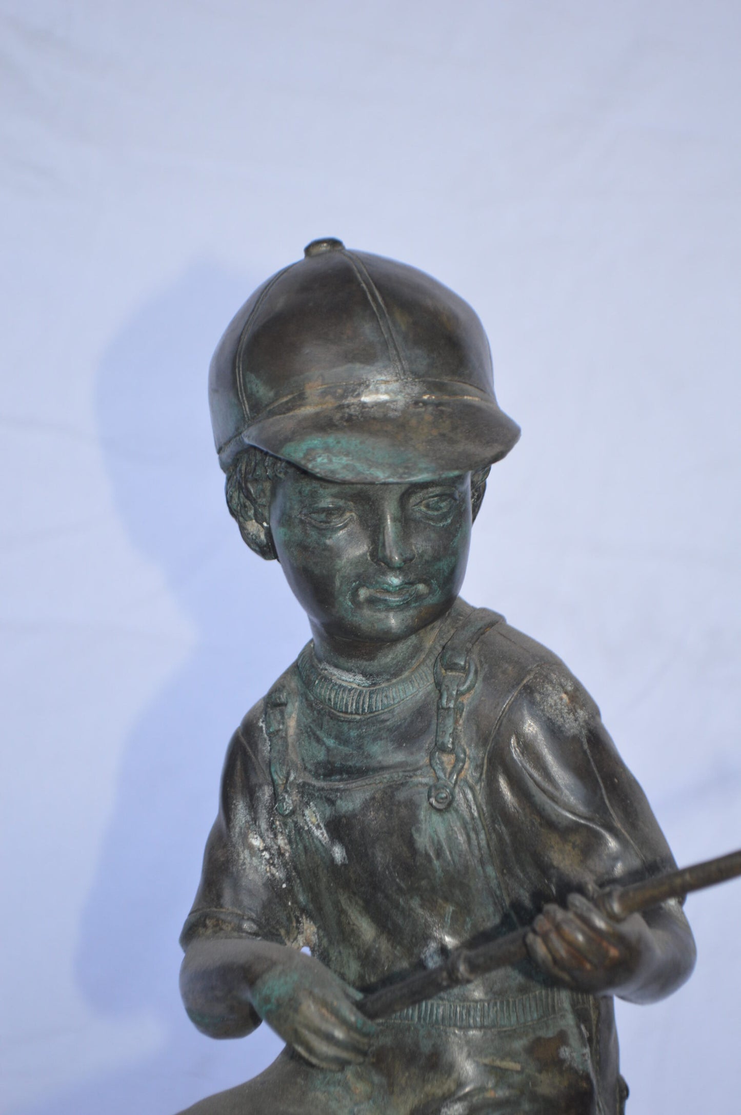 A Boy on a high Chair Fishing Bronze Statue - Size: 16"L x 14"W x 28"H.
