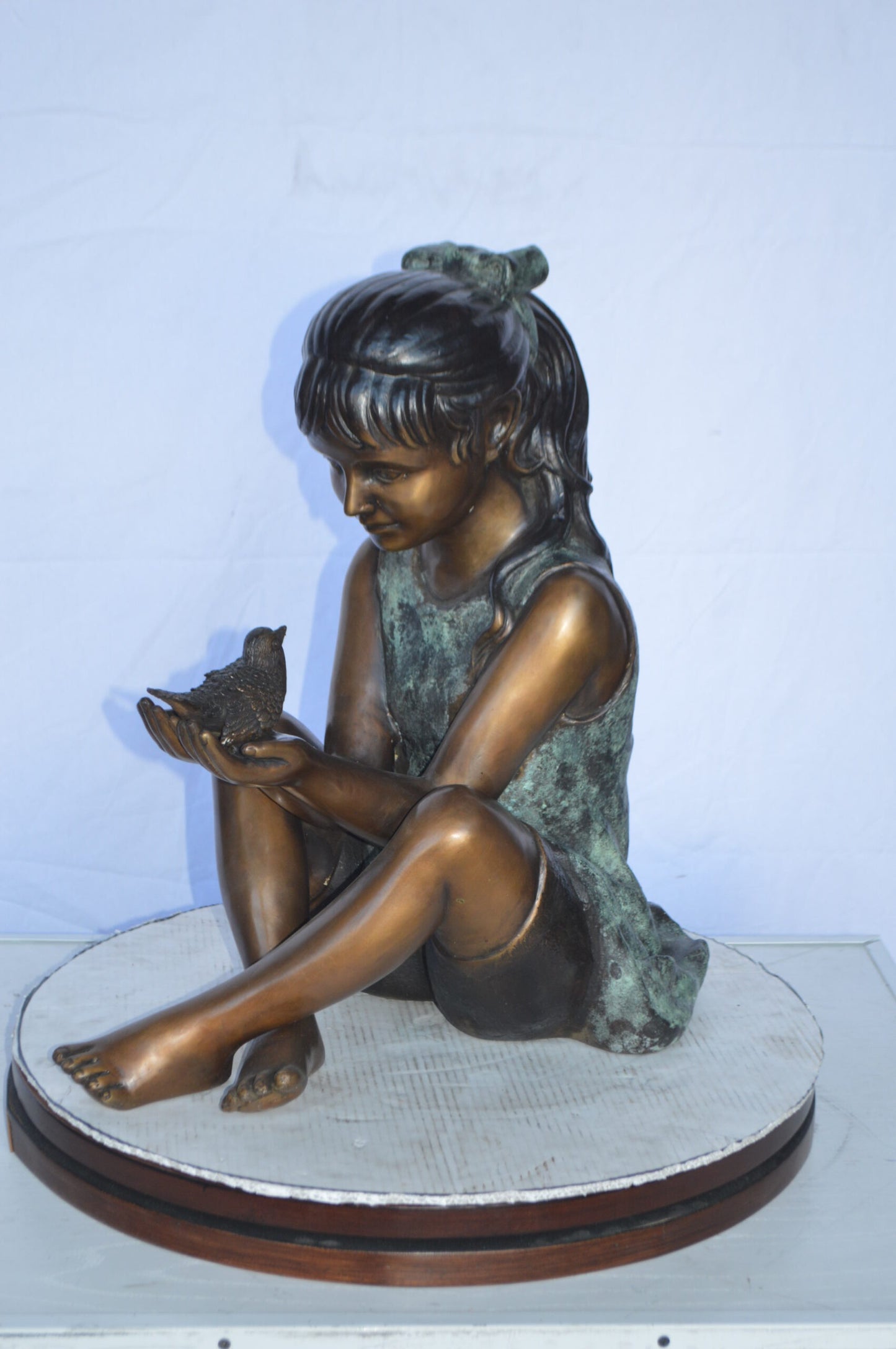Girl Knees Up Holding a Bird Bronze Statue - Size: 22"L x 14"W x 24"H.