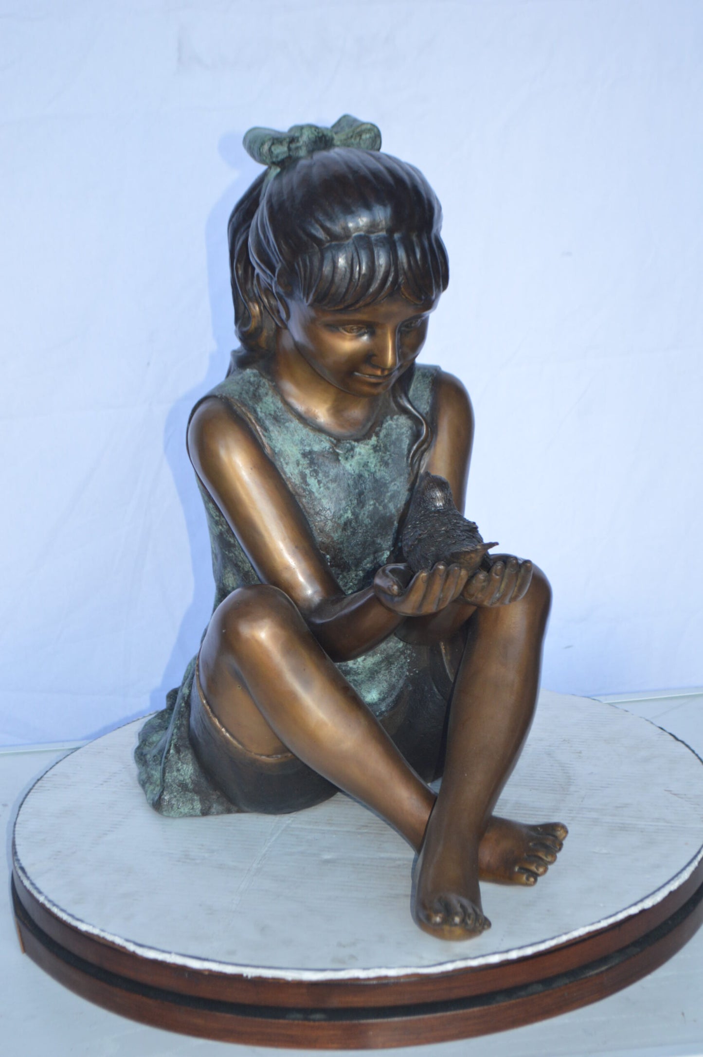 Girl Knees Up Holding a Bird Bronze Statue - Size: 22"L x 14"W x 24"H.
