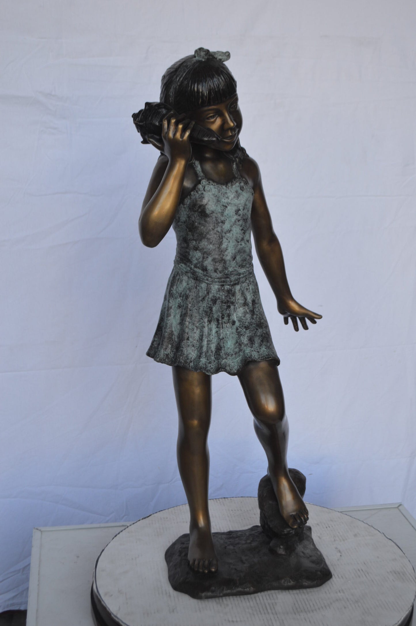 Standing Girl Listening to a Shell Bronze Statue - Size: 16"L x 12"W x 37"H.