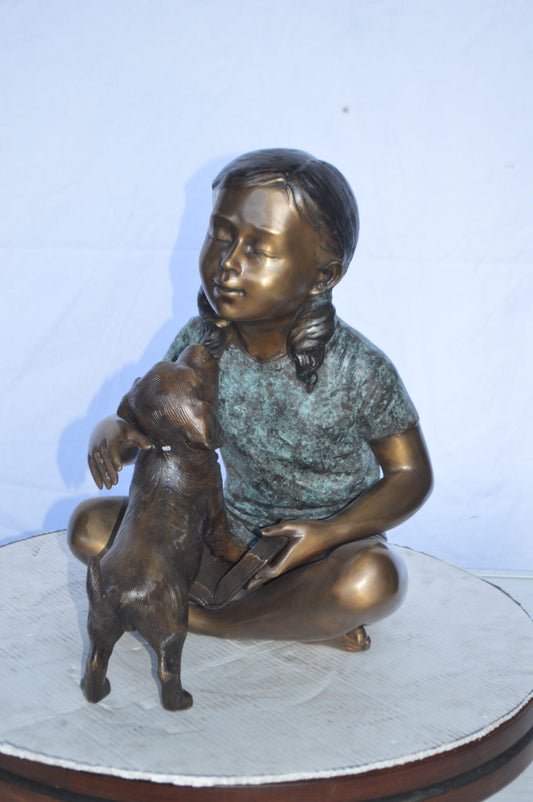 Girl Petting her Dog While Reading Bronze Statue -  Size: 13"L x 18"W x 18"H.