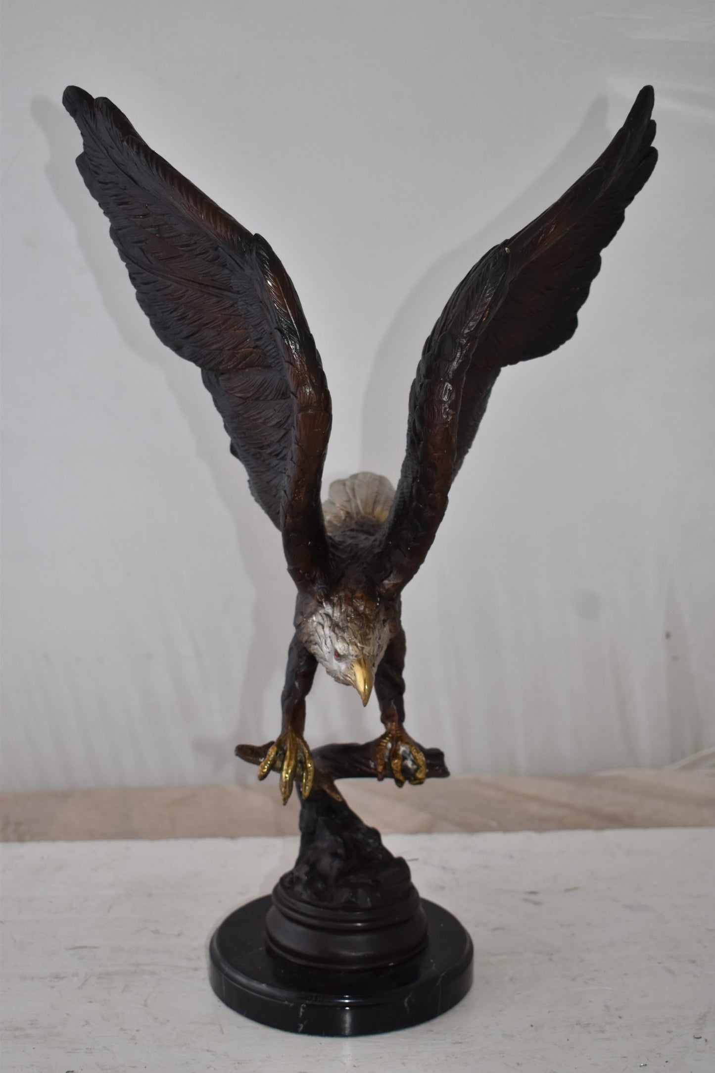 Eagle Holding His Fish Prey Flying Away Bronze Statue Size: 14" x 11" x 23"H
