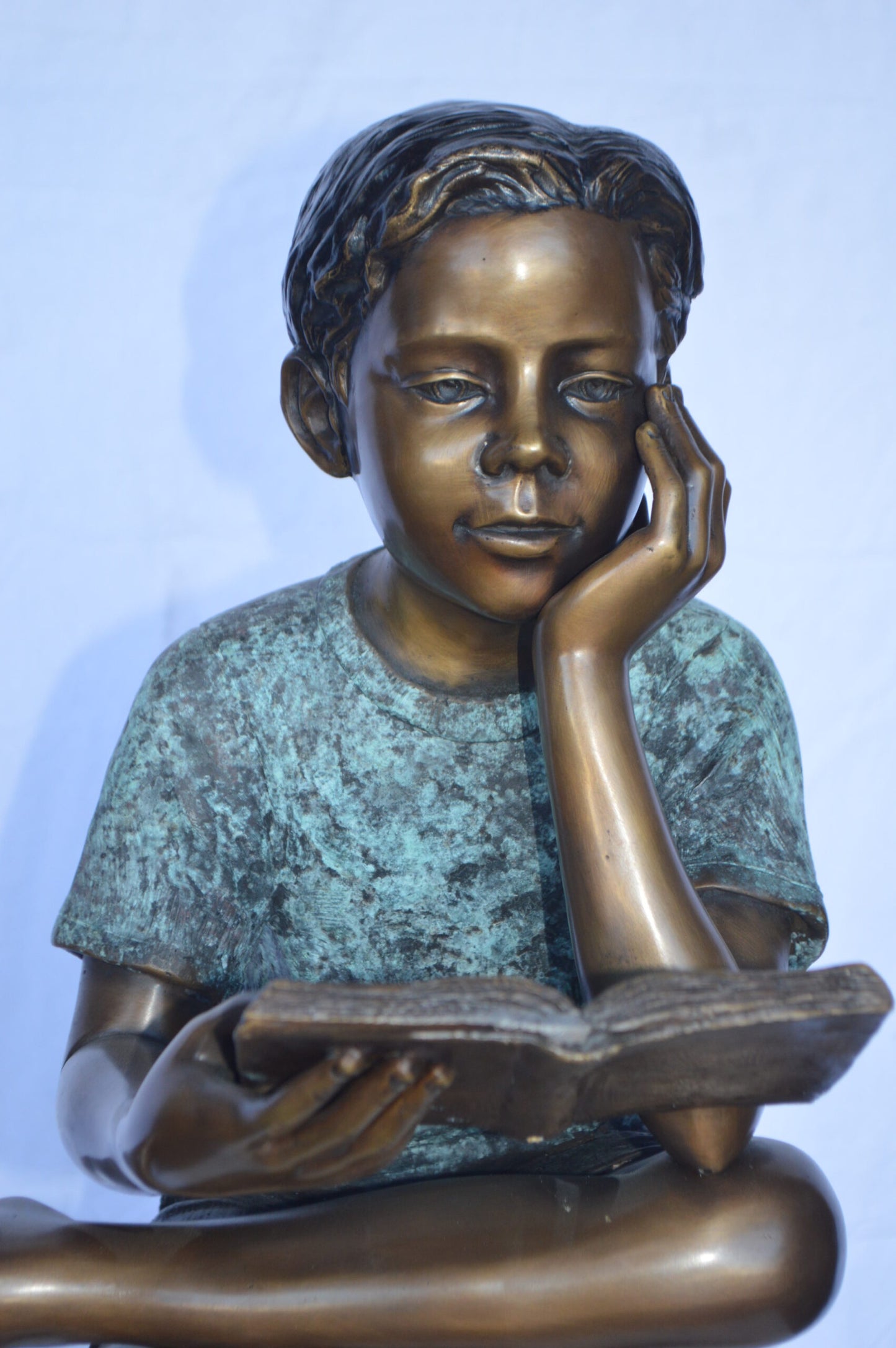 Boy Sitting on a Stump Reading a Book - Size: 18"L x 20"W x 35"H.