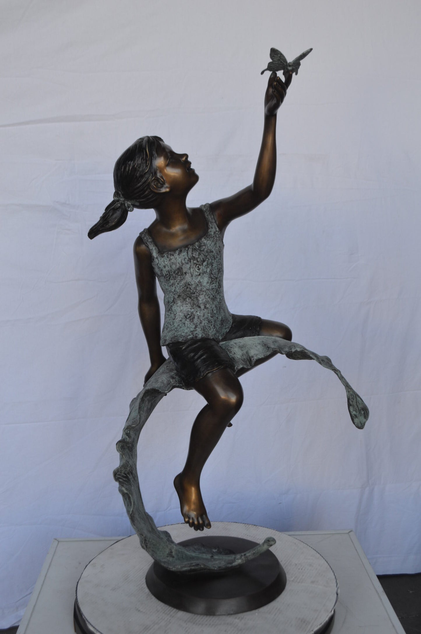 Girl on A Leaf Playing with Butterfly Bronze State - Size: 27"L x 15"W x 45"H.