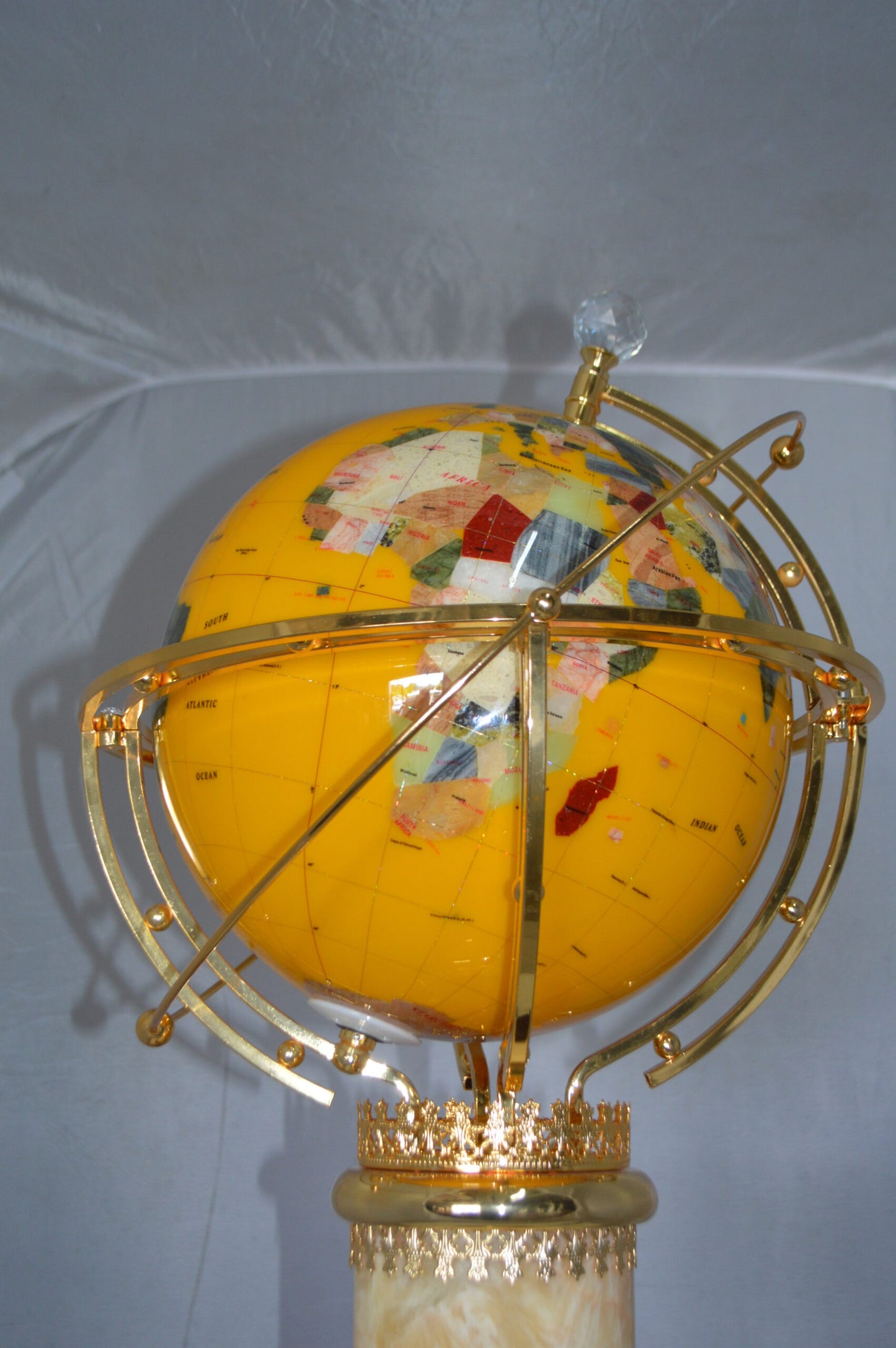 Illuminated Yellow World Globe Rotated by motor - Size: 19"L x 19"W x 42"H.