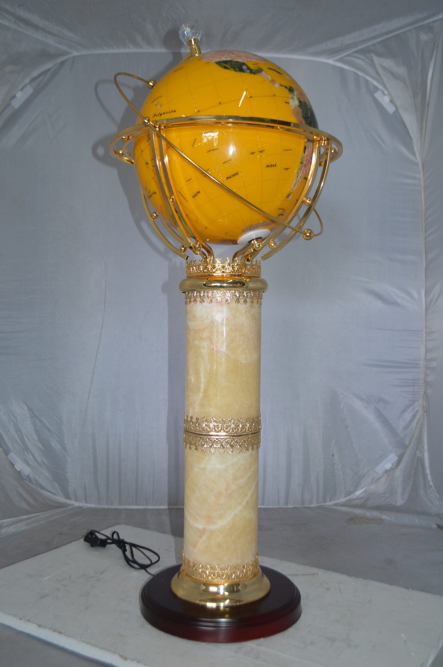 Illuminated Yellow World Globe Rotated by motor - Size: 19"L x 19"W x 42"H.
