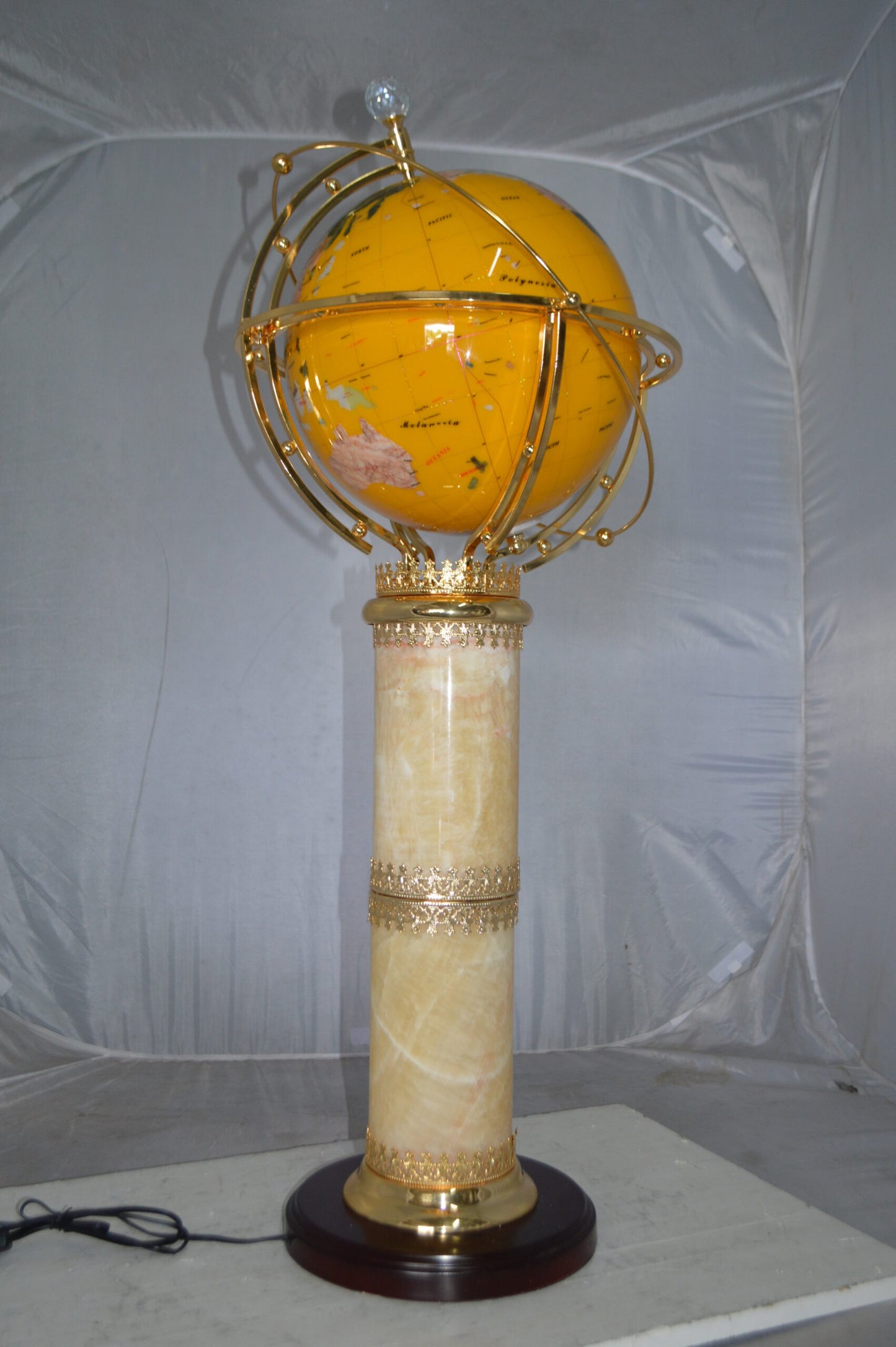 Illuminated Yellow World Globe Rotated by motor - Size: 19"L x 19"W x 42"H.