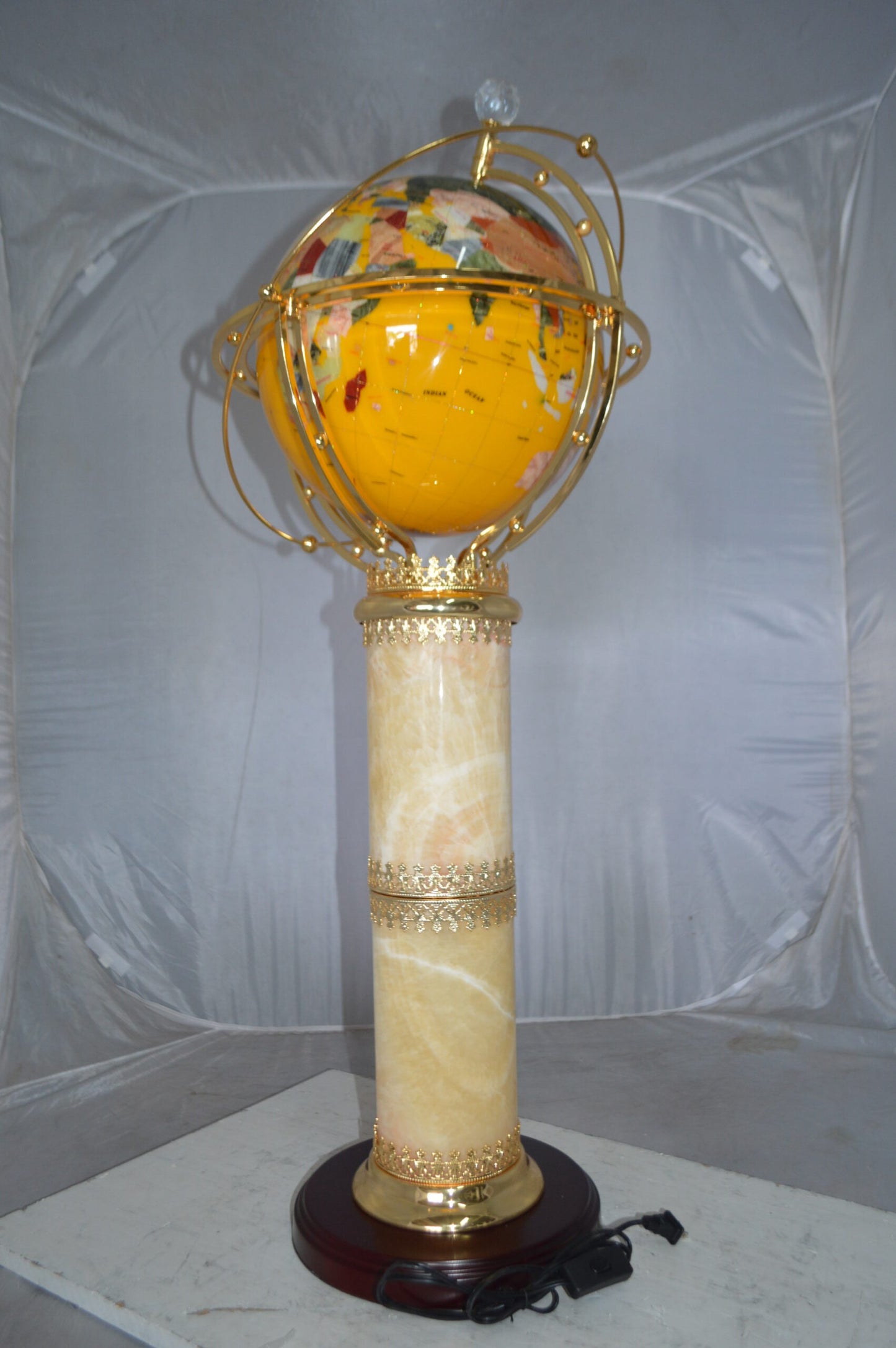 Illuminated Yellow World Globe Rotated by motor - Size: 19"L x 19"W x 42"H.