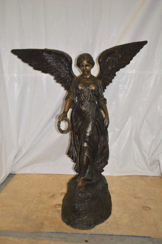 Angel Standing on a Rock Bronze Statue - Size: 60"L x 36"W x 71"H.