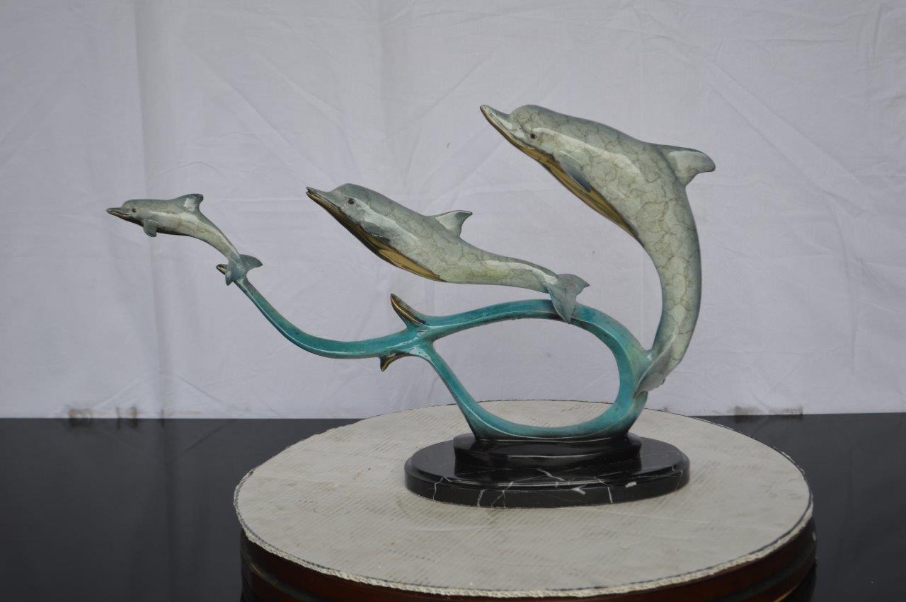 Three dolphins swimming bronze state - Size: 26"L x 7"W x 16"H.