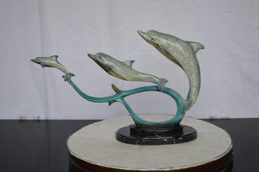 Three dolphins swimming bronze state - Size: 26"L x 7"W x 16"H.