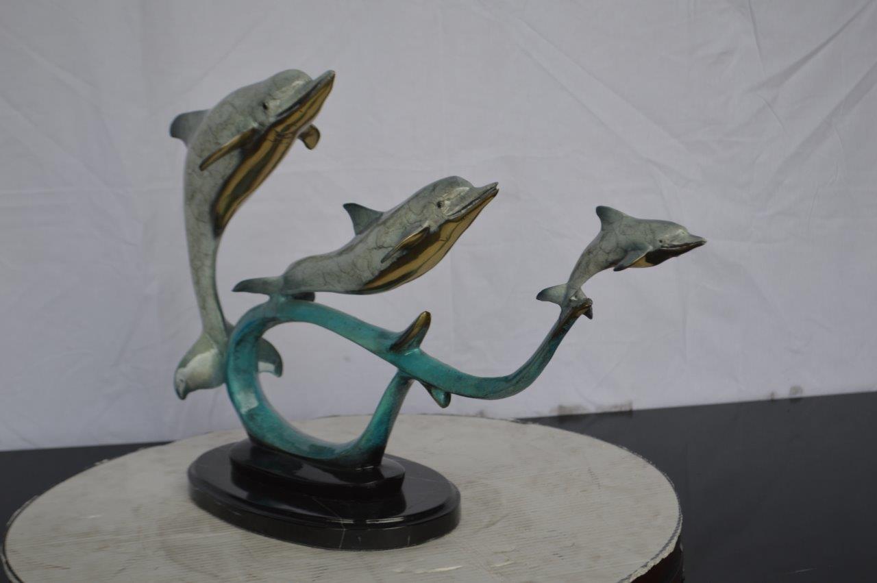 Three dolphins swimming bronze state - Size: 26"L x 7"W x 16"H.