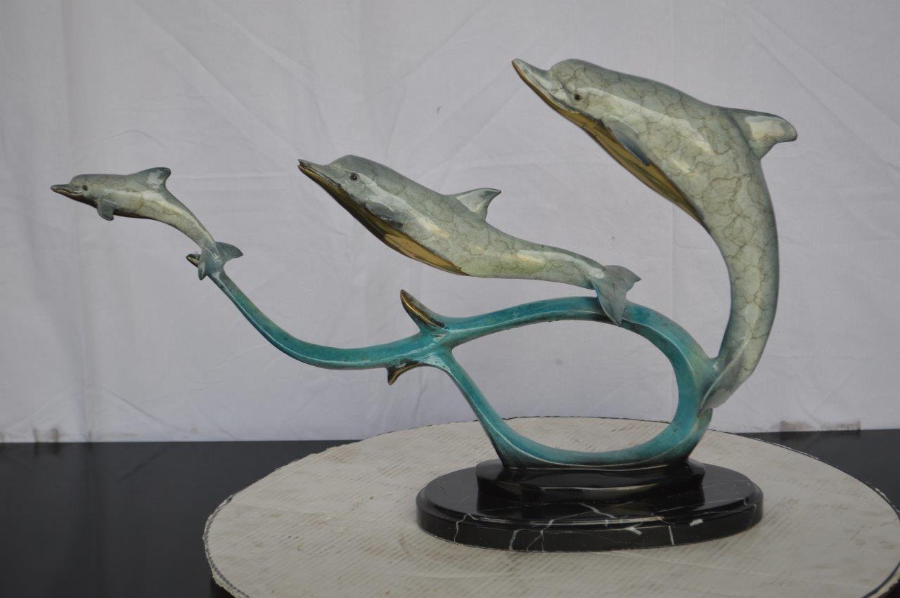 Three dolphins swimming bronze state - Size: 26"L x 7"W x 16"H.