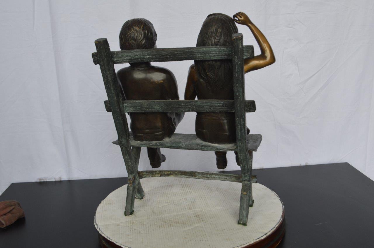 Two Kids Sitting On a Bench Bronze Statue - Size: 20"L x 18"W x 24"H.