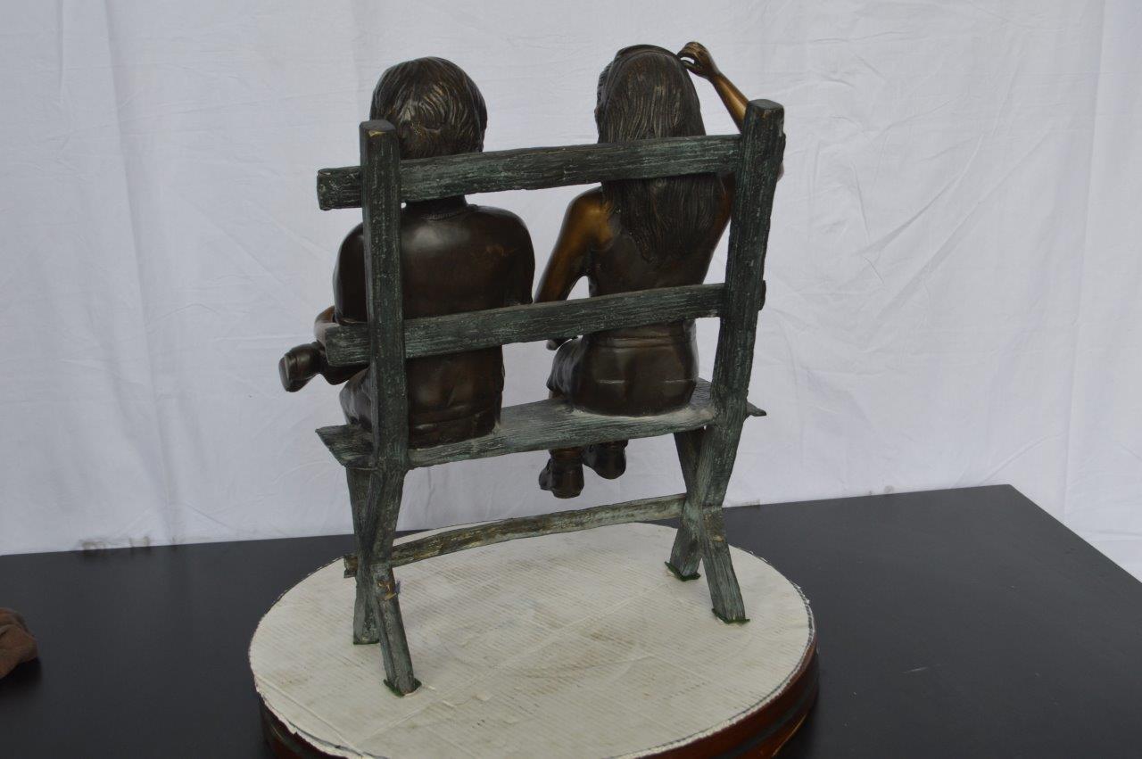 Two Kids Sitting On a Bench Bronze Statue - Size: 20"L x 18"W x 24"H.
