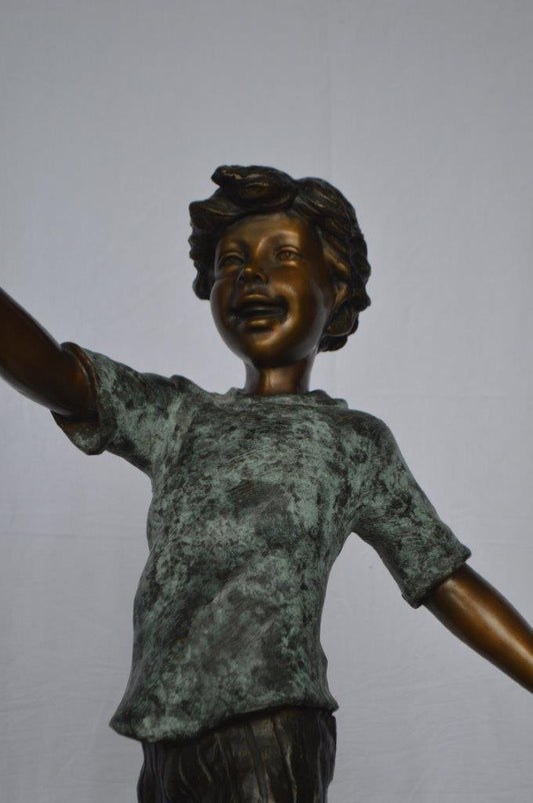 Boy on Ball Bronze Statue - Street Performer - Size: 23"L x 12"W x 39"H.