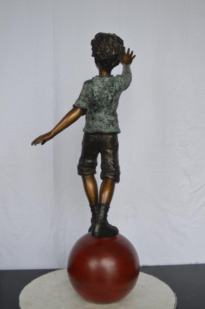 Boy on Ball Bronze Statue - Street Performer - Size: 23"L x 12"W x 39"H.