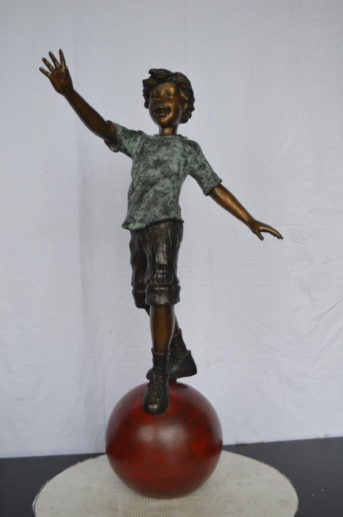 Boy on Ball Bronze Statue - Street Performer - Size: 23"L x 12"W x 39"H.
