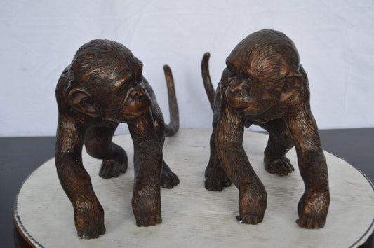 Pair of monkeys looking at each other bronze statue - Size: 23"L x 7"W x 11"H.