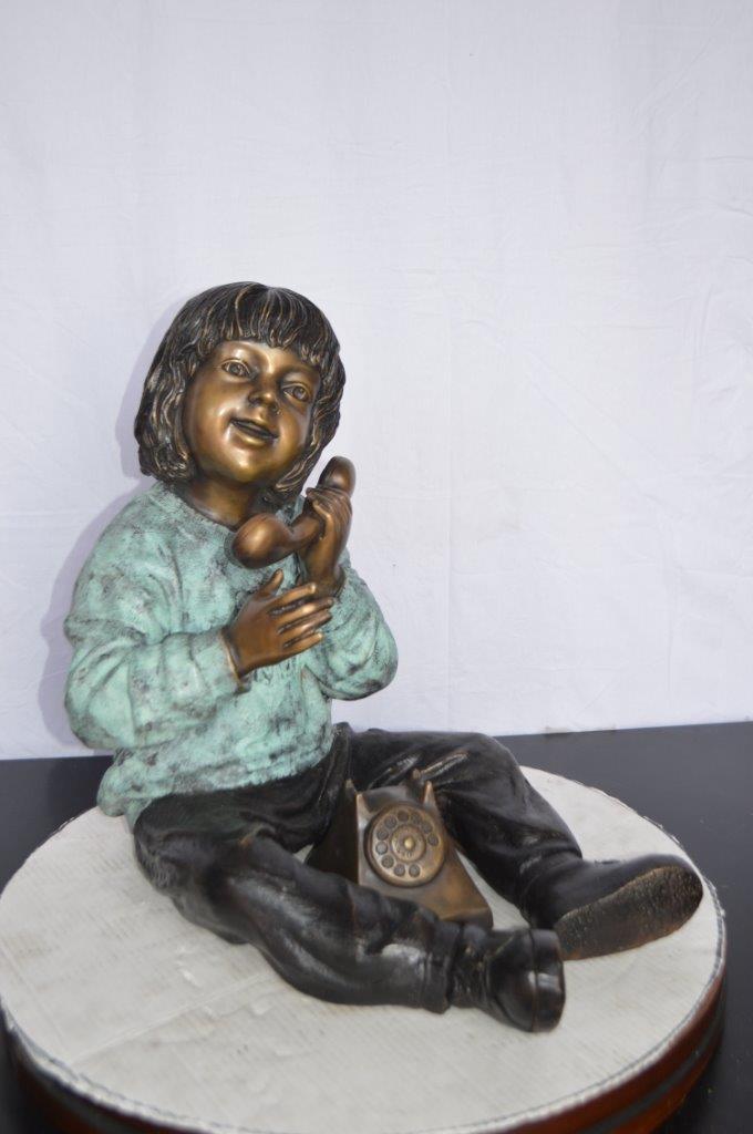 Young Child With an Old Telephone Bronze Statue - Size: 21"L x 14"W x 19"H.