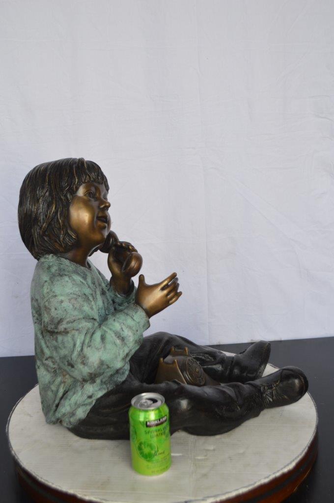 Young Child With an Old Telephone Bronze Statue - Size: 21"L x 14"W x 19"H.