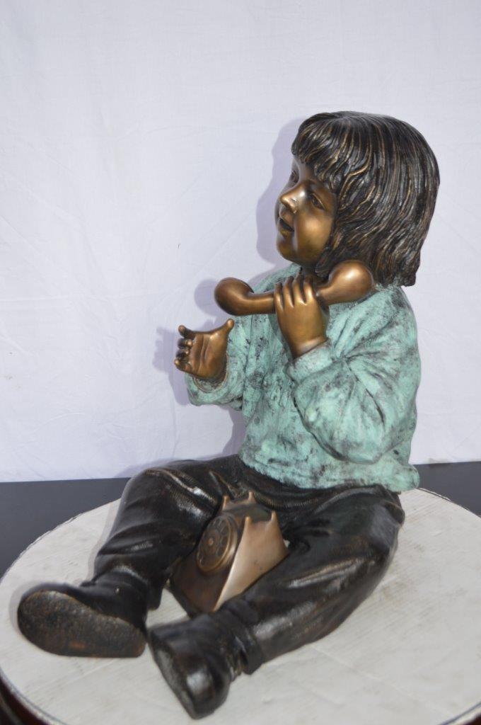 Young Child With an Old Telephone Bronze Statue - Size: 21"L x 14"W x 19"H.