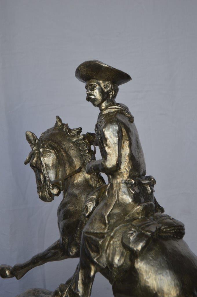 Remington Cowboy silver finished Bronze Statue - Size: 24"L x 9"W x 24"H.
