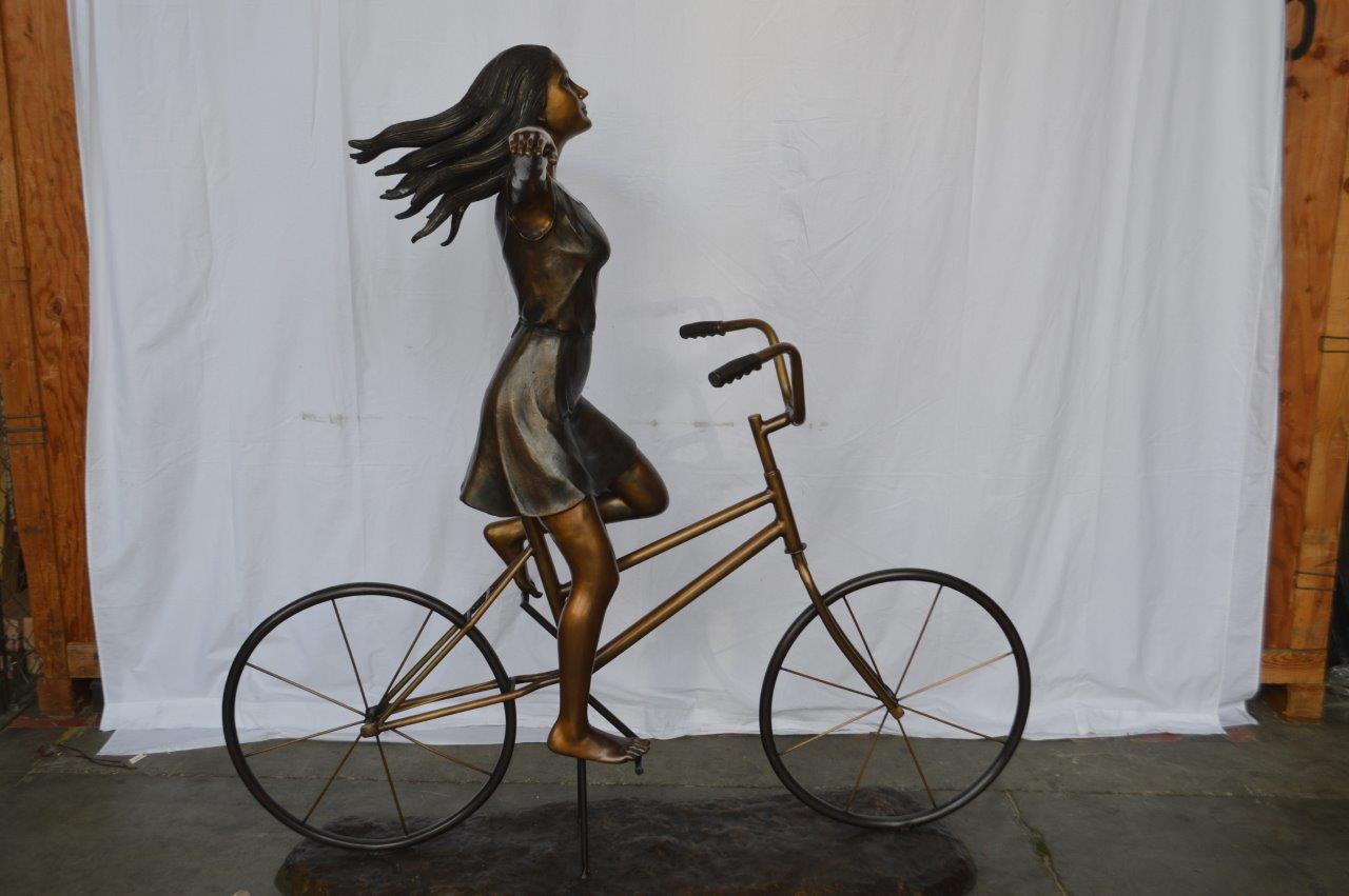 Girl Riding Hands Free life Size Bronze Statue - Size: 53"L x 62"W x 61"H.