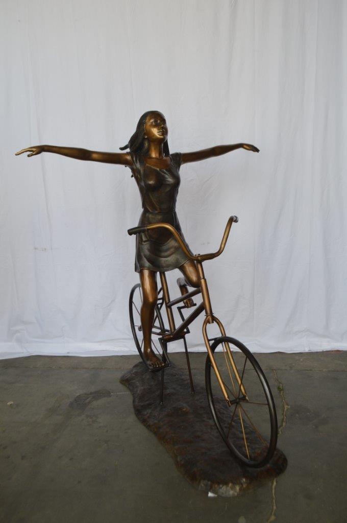 Girl Riding Hands Free life Size Bronze Statue - Size: 53"L x 62"W x 61"H.