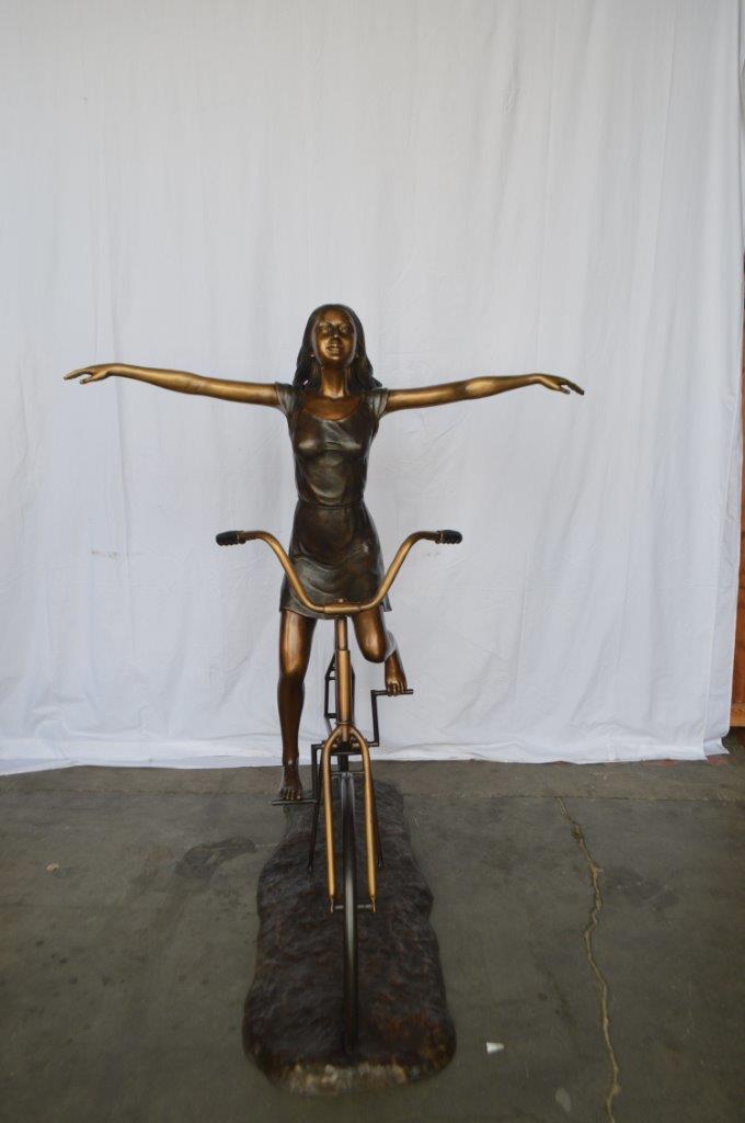Girl Riding Hands Free life Size Bronze Statue - Size: 53"L x 62"W x 61"H.