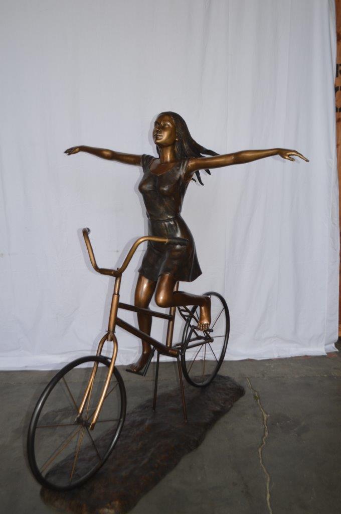 Girl Riding Hands Free life Size Bronze Statue - Size: 53"L x 62"W x 61"H.