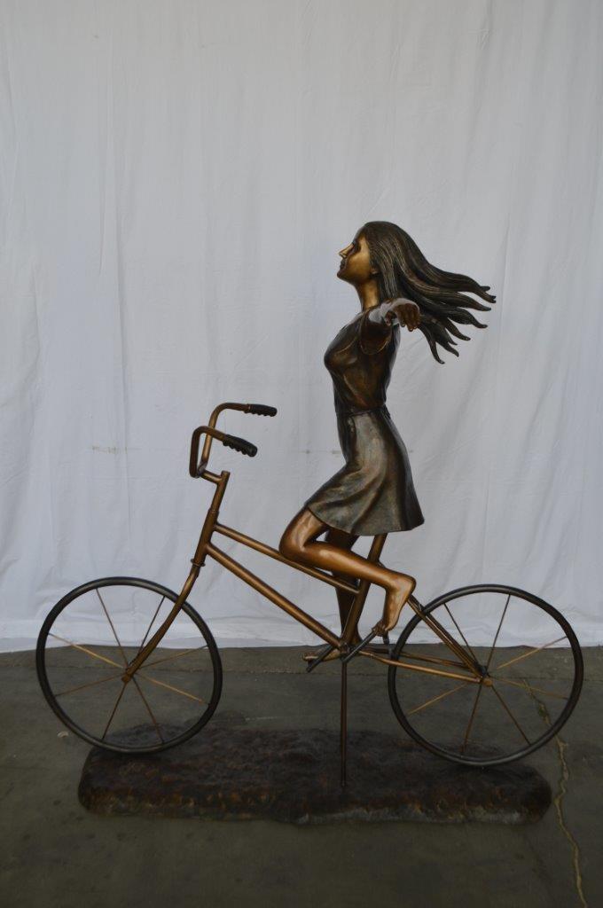 Girl Riding Hands Free life Size Bronze Statue - Size: 53"L x 62"W x 61"H.