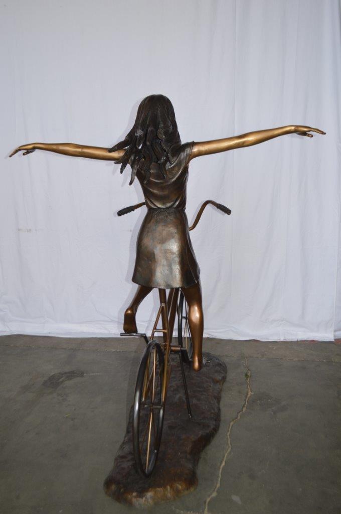 Girl Riding Hands Free life Size Bronze Statue - Size: 53"L x 62"W x 61"H.