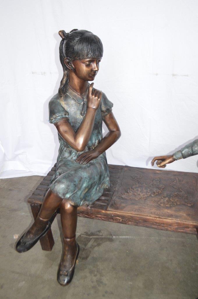 Young Couple Reviewing a World Map Bronze Statue -  Size: 32"L x 47"W x 42"H.