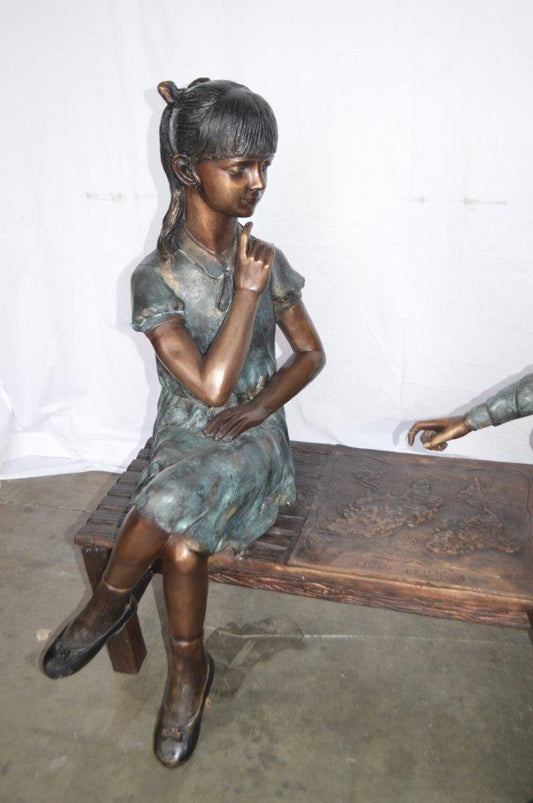 Young Couple Reviewing a World Map Bronze Statue - Size: 32"L x 47"W x 42"H.