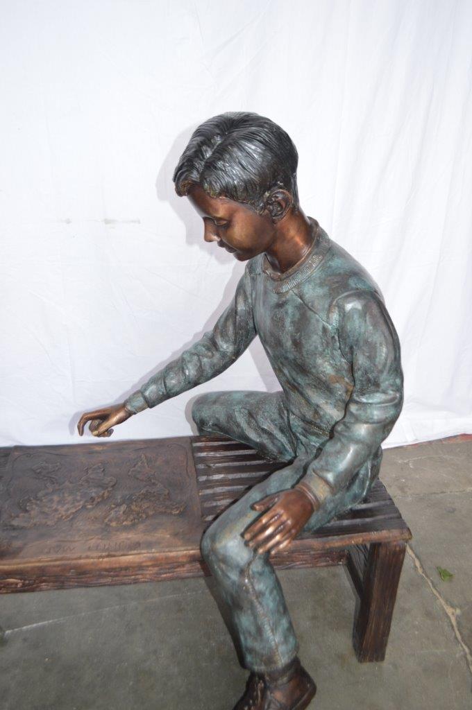 Young Couple Reviewing a World Map Bronze Statue - Size: 32"L x 47"W x 42"H.