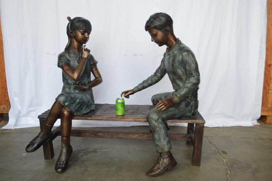 Young Couple Reviewing a World Map Bronze Statue -  Size: 32"L x 47"W x 42"H.