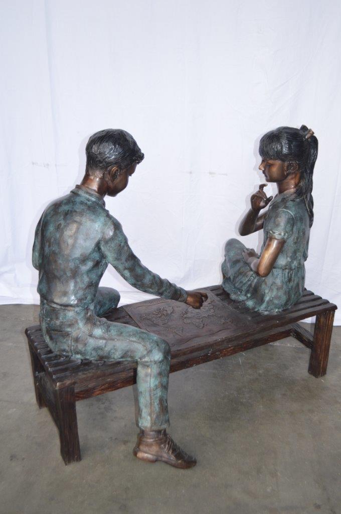 Young Couple Reviewing a World Map Bronze Statue - Size: 32"L x 47"W x 42"H.
