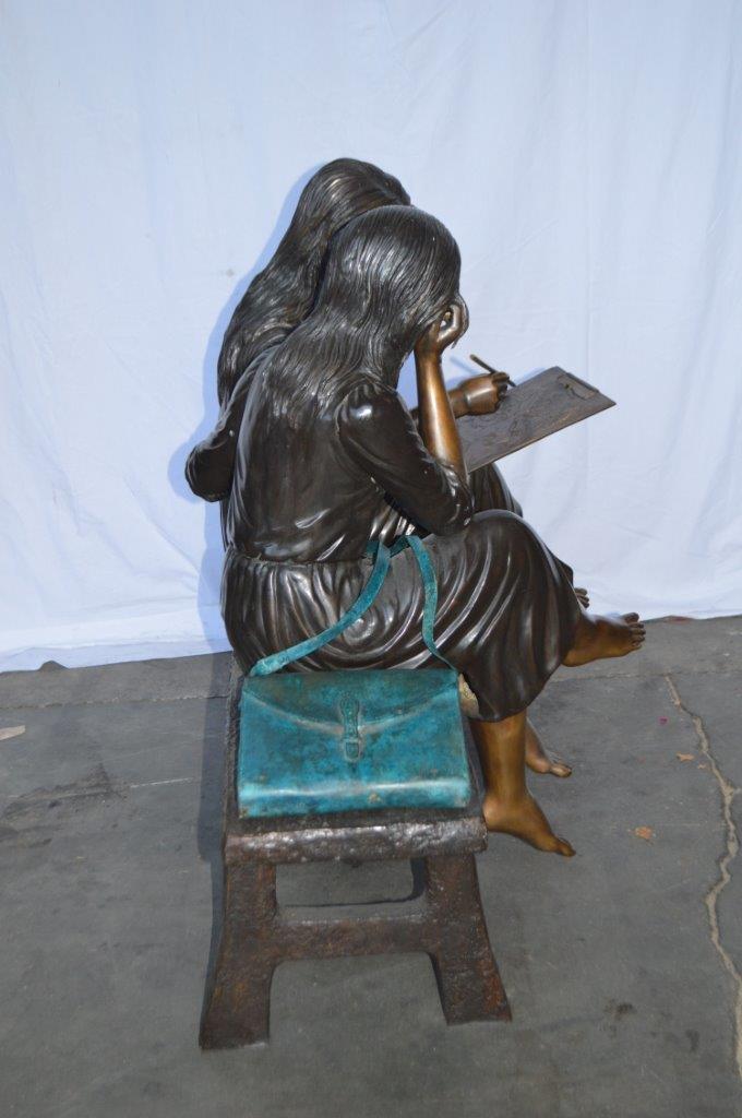 Two Schoolgirls Sitting On a Bench Bronze Statue - Size: 45"L x 24"W x 41"H.