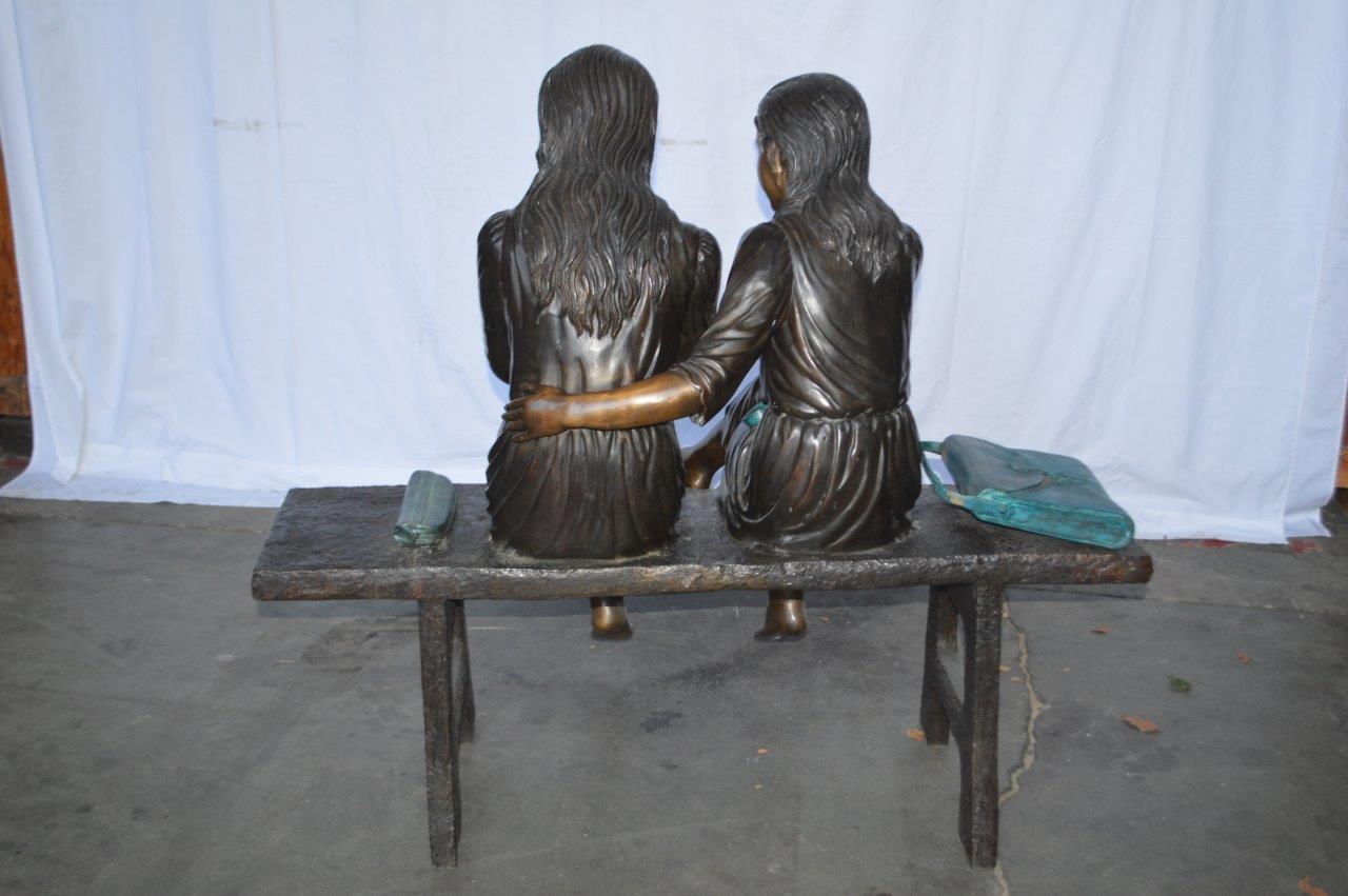 Two Schoolgirls Sitting On a Bench Bronze Statue - Size: 45"L x 24"W x 41"H.
