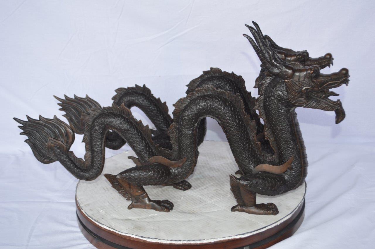Pair of Dragons sitting side by side bronze statues - Size: 31"L x 7"W x 16"H.