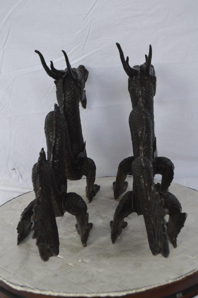 Pair of Dragons sitting side by side bronze statues - Size: 31"L x 7"W x 16"H.