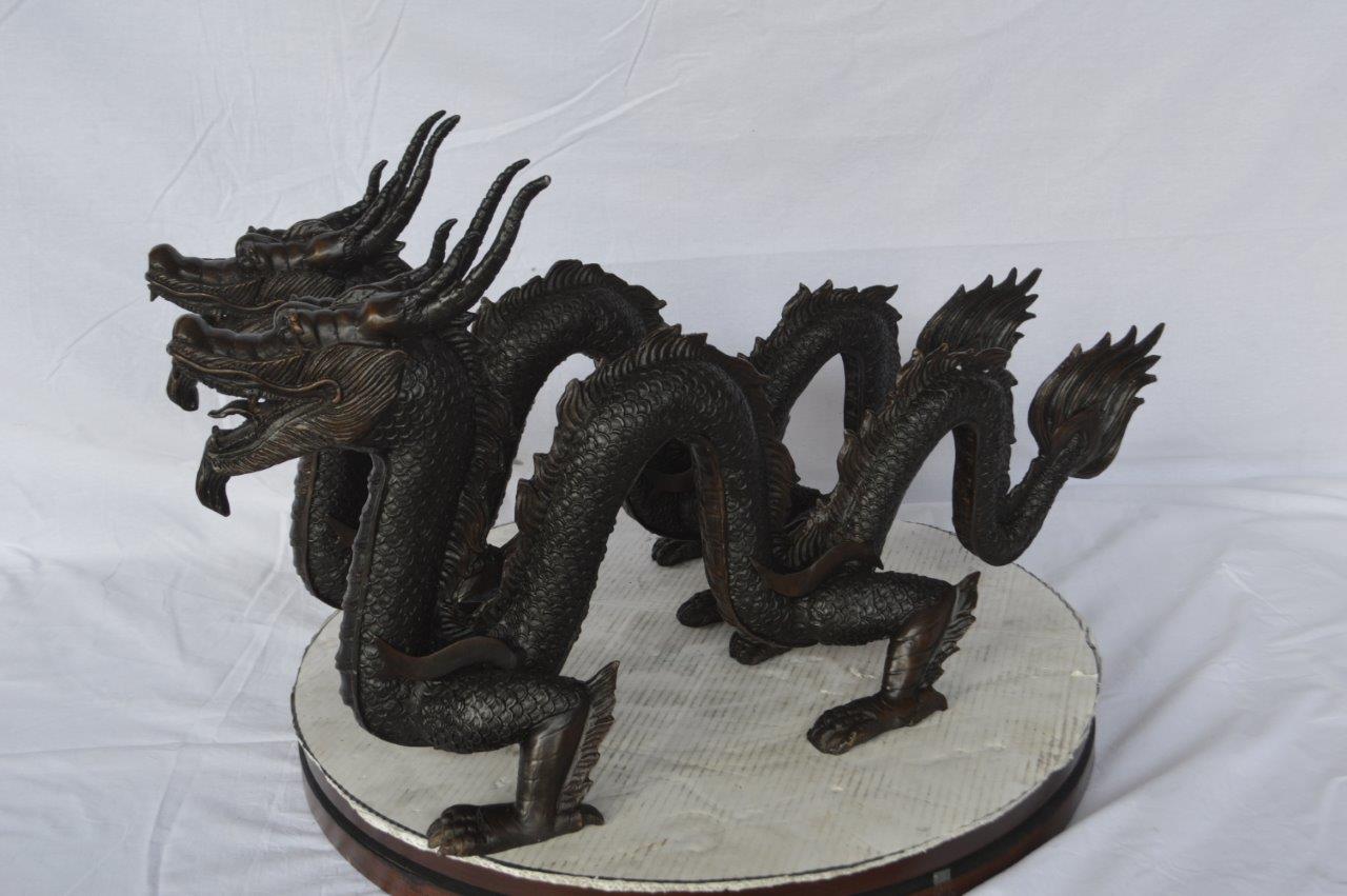 Pair of Dragons sitting side by side bronze statues - Size: 31"L x 7"W x 16"H.