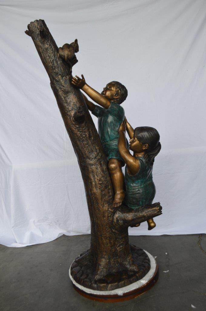 Children reaching up tree for a cat bronze statue - Size: 24"L x 21"W x 64"H.